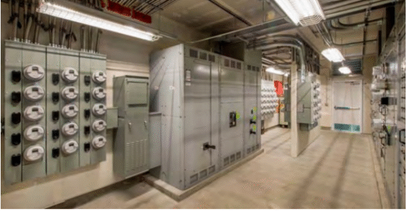 Technician inspecting an underground electrical vault using advanced acoustic imaging equipment to detect early partial discharge and prevent arc flash hazards.